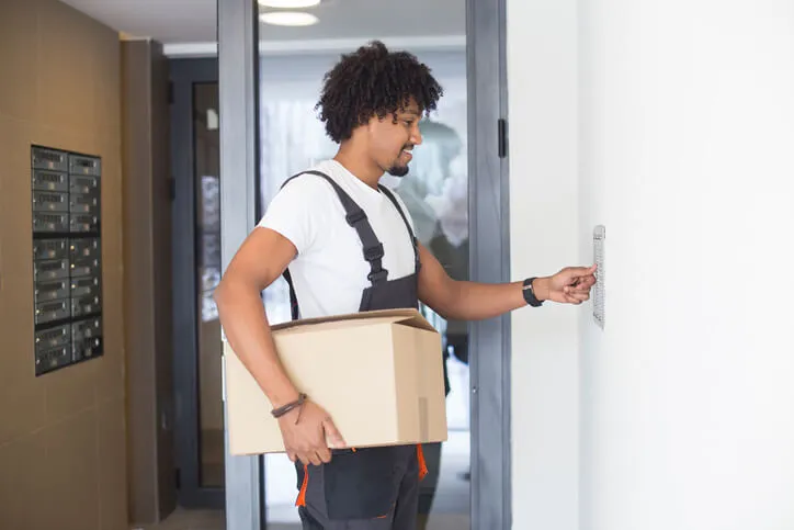 Man-using-voip-intercom-to-open-his-apartment